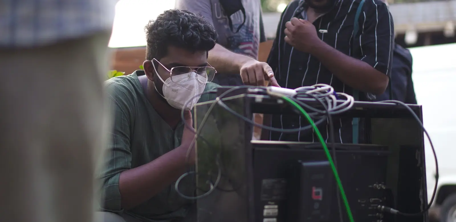Amal Manoj on set, checking a shot on the monitor