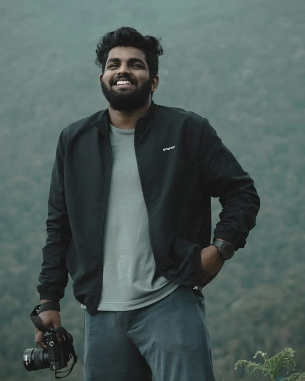 Portrait of Amal Manoj holding a camera
